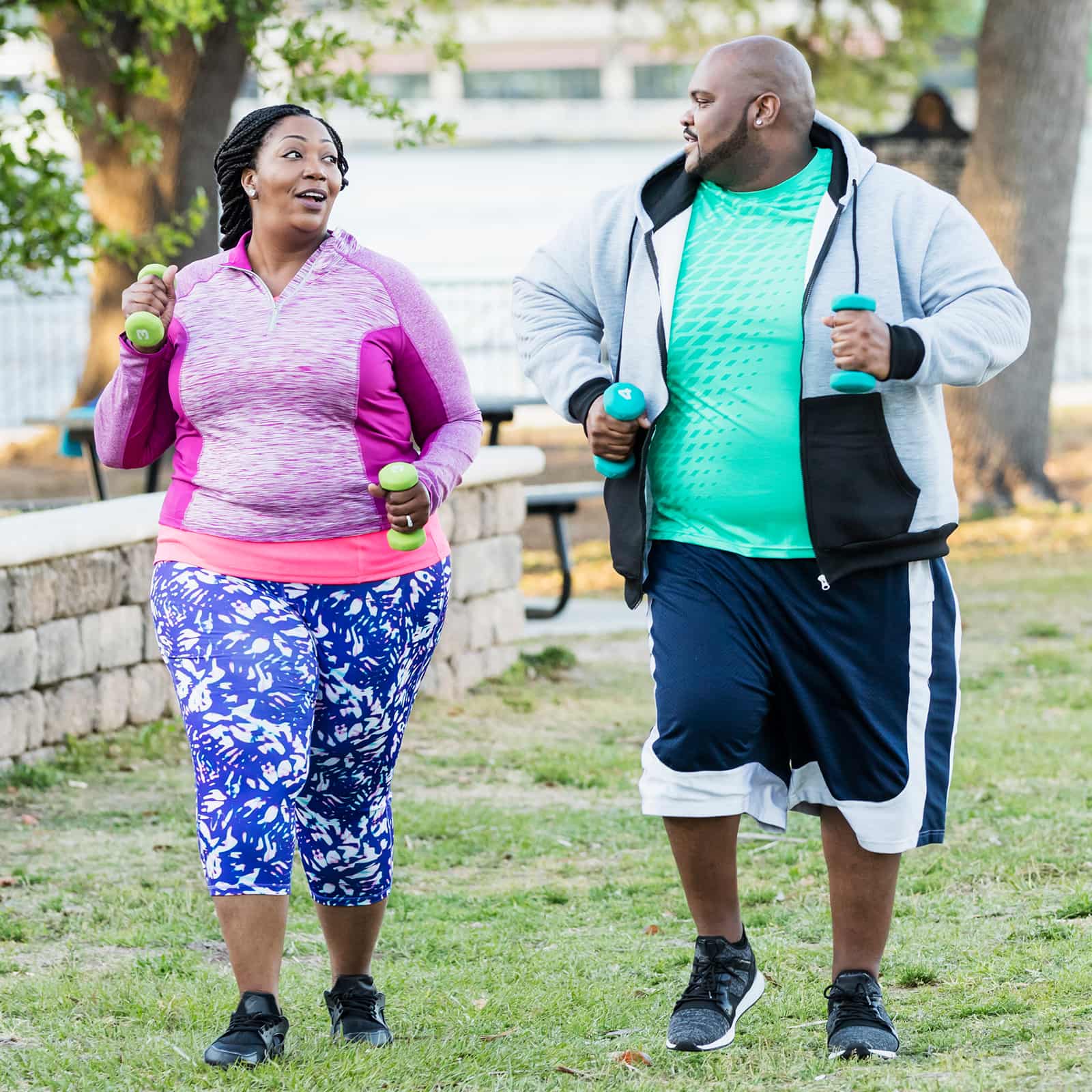 African-American couple exercising, power walking
