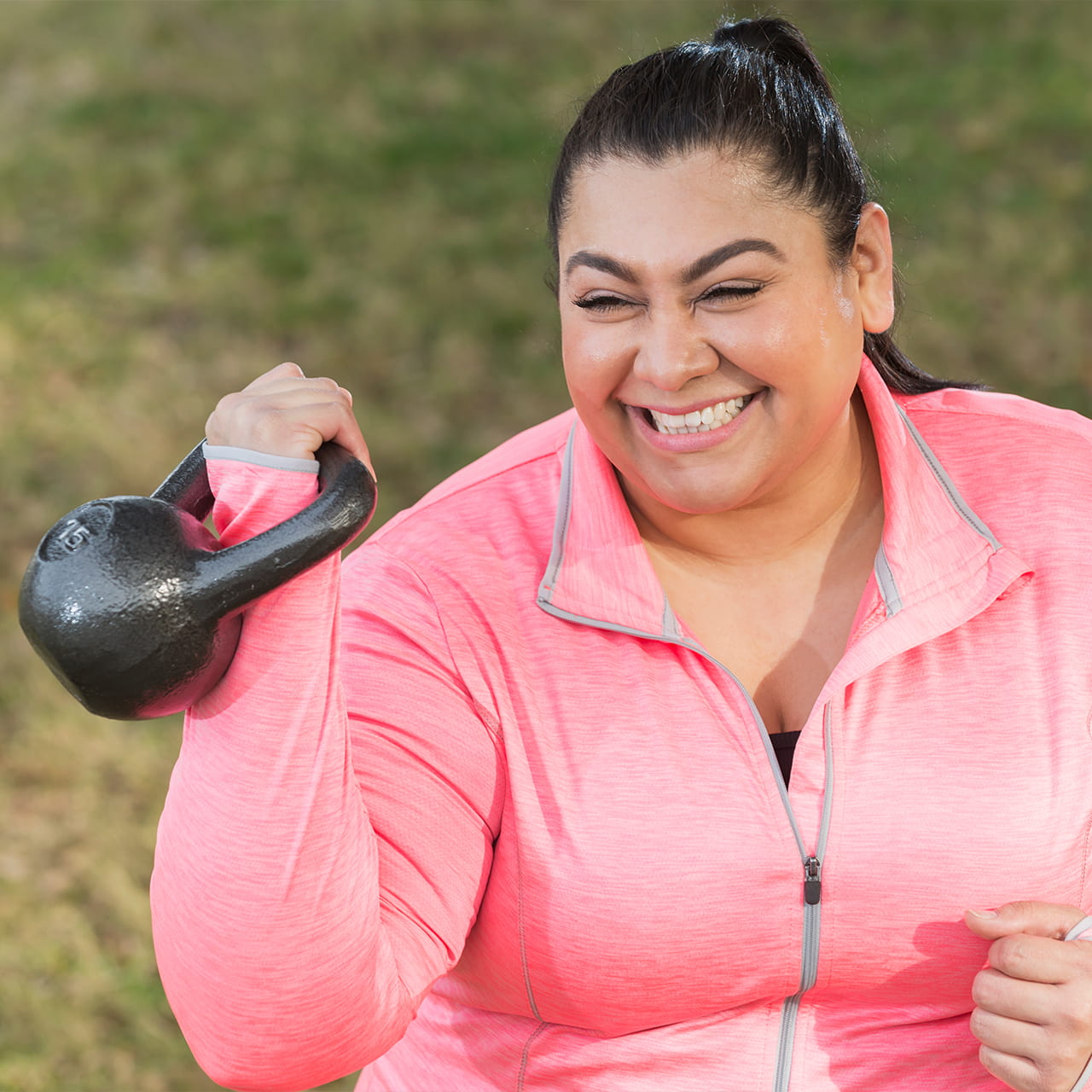 Hispanic woman exercising to lose weight with kettlebell